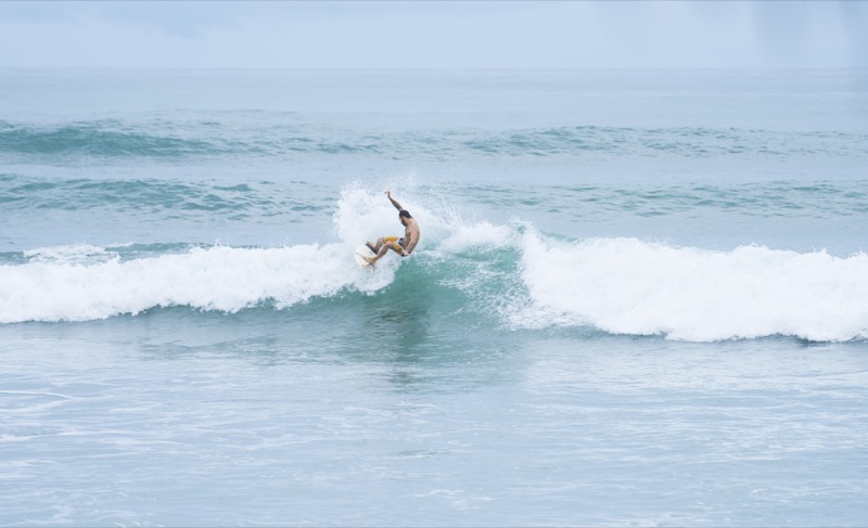 A surfer riding a wave at Playa Carmen, Costa Rica